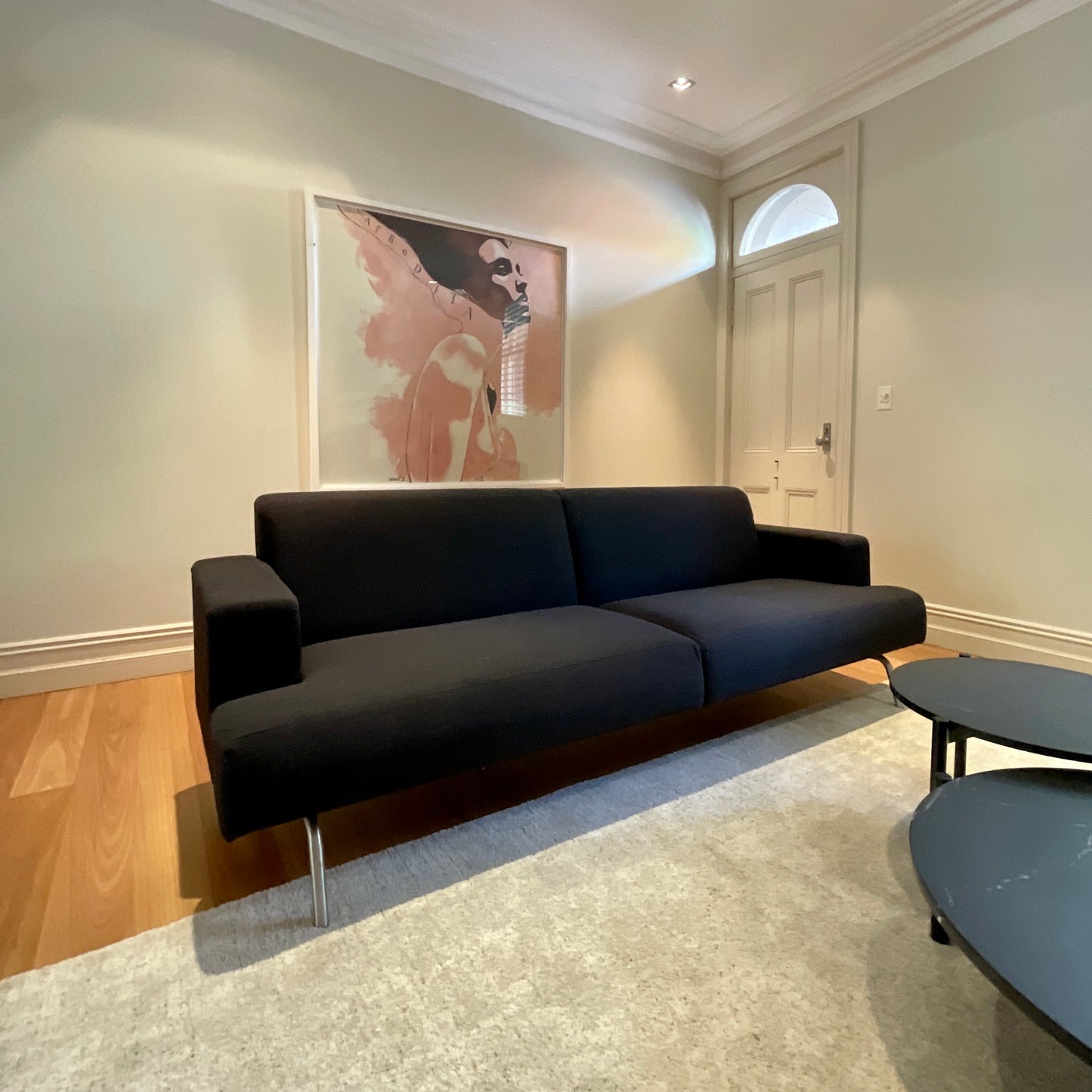 Norman + Quaine Columbia three seat sofa in black wool with steel base, pre-owned designer furniture