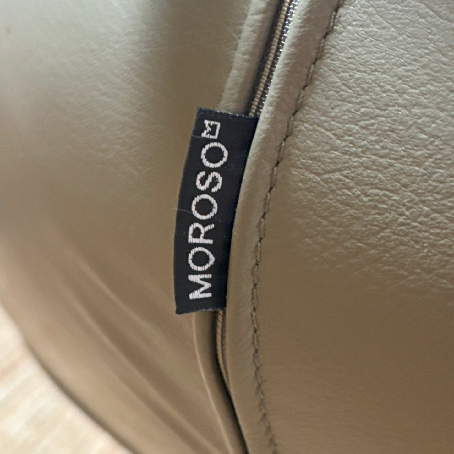 Close-up of a beige leather product with a Moroso label.