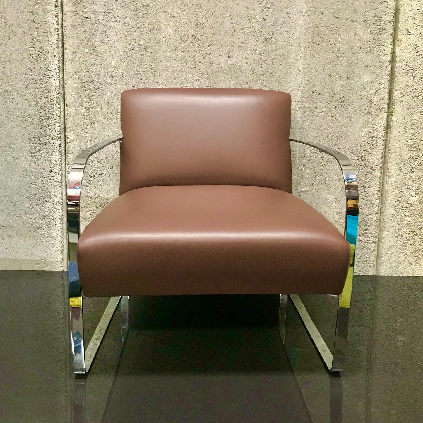 Brown leather armchair with polished metal frame, pre-owned designer furniture